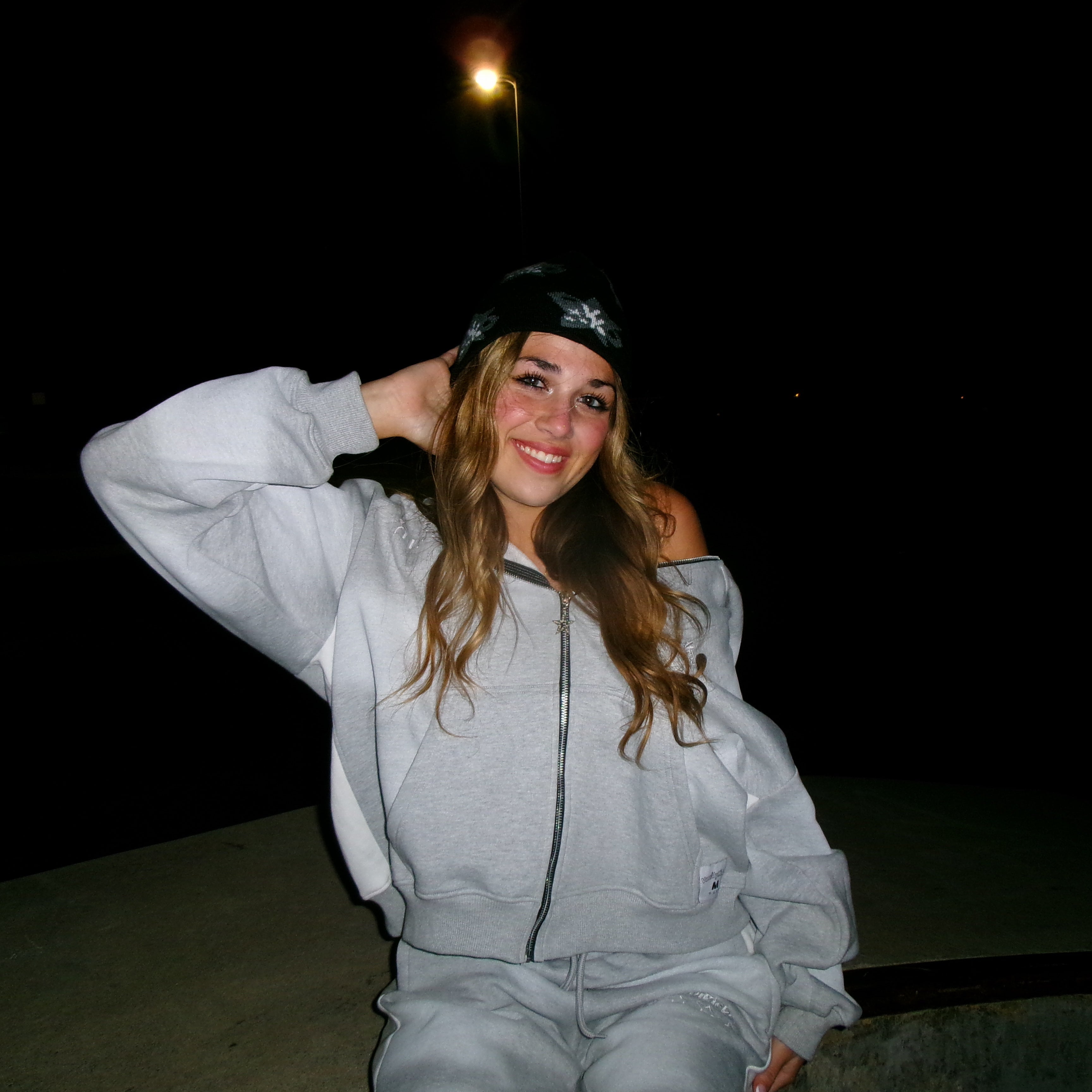 Model wearing the Art of Disruption beanie and zip up
