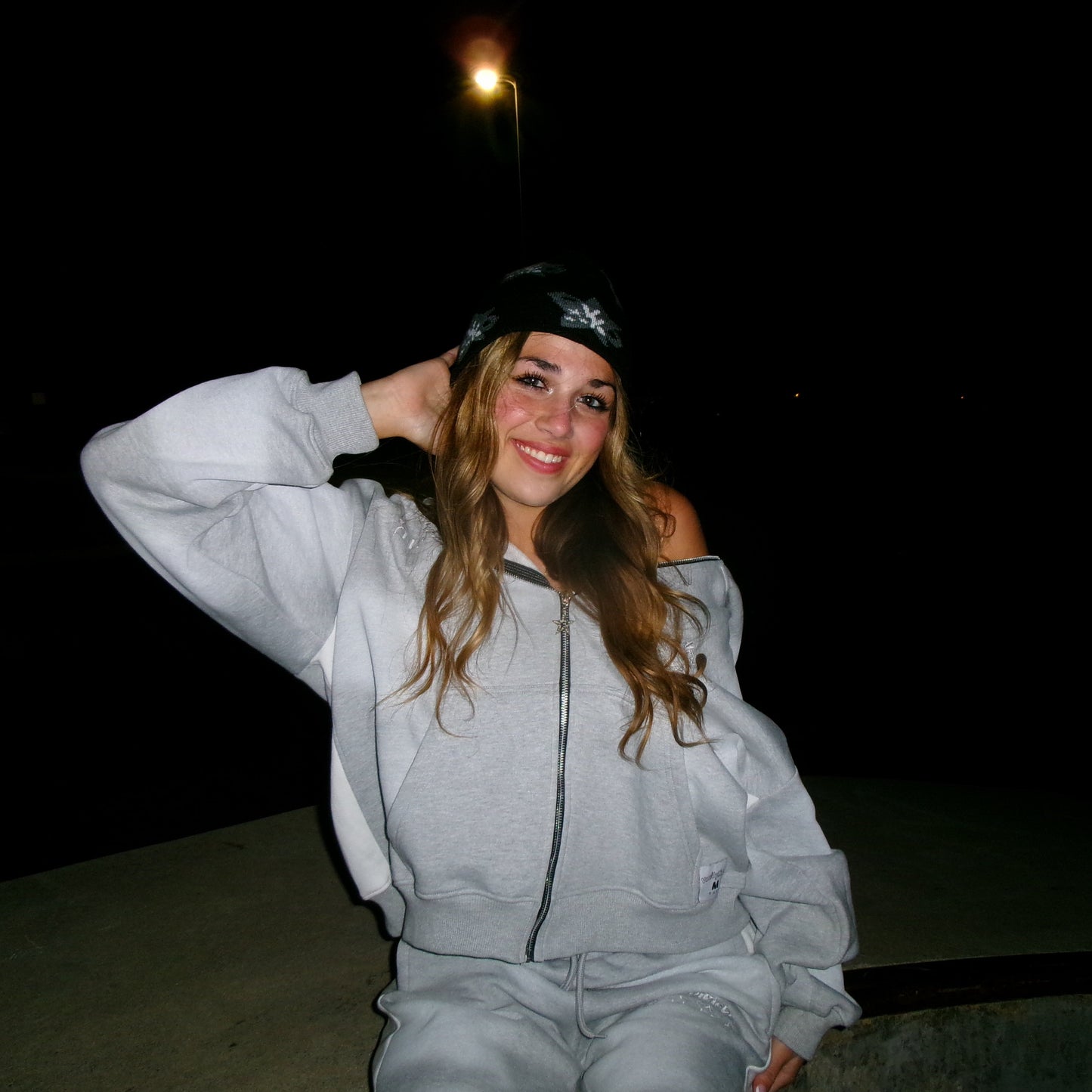 Model wearing the Art of Disruption beanie and zip up
